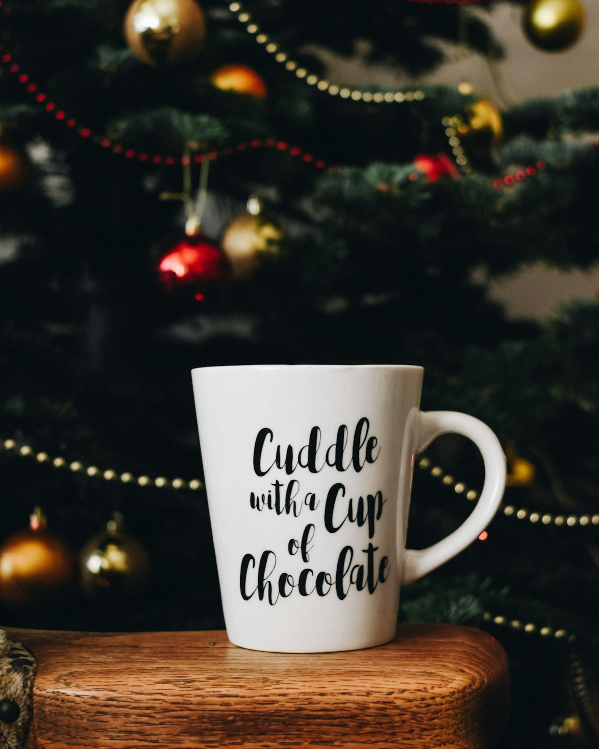 white mug near Christmas tree