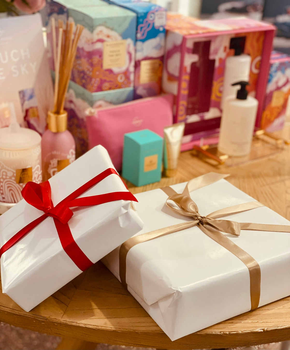 two wrapped gifts sitting on top of a table