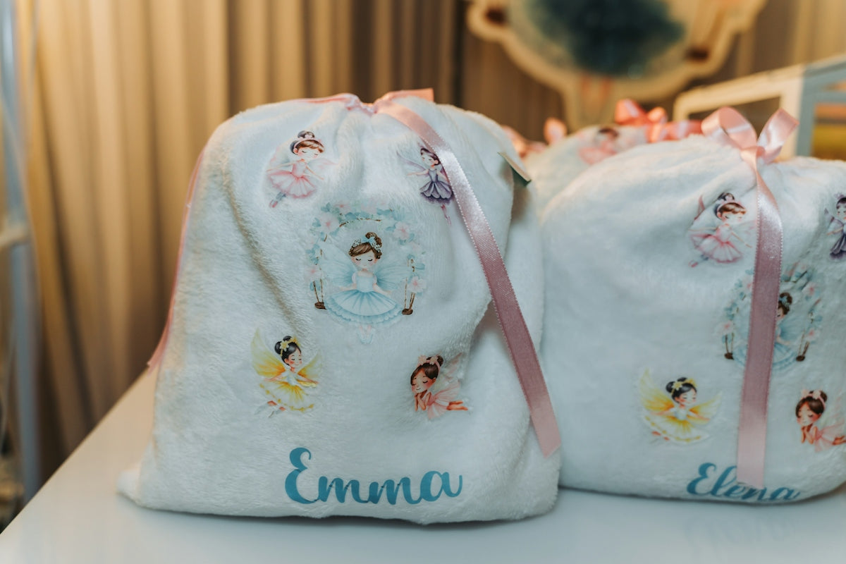 White drawstring bags with ballet dancer designs and names