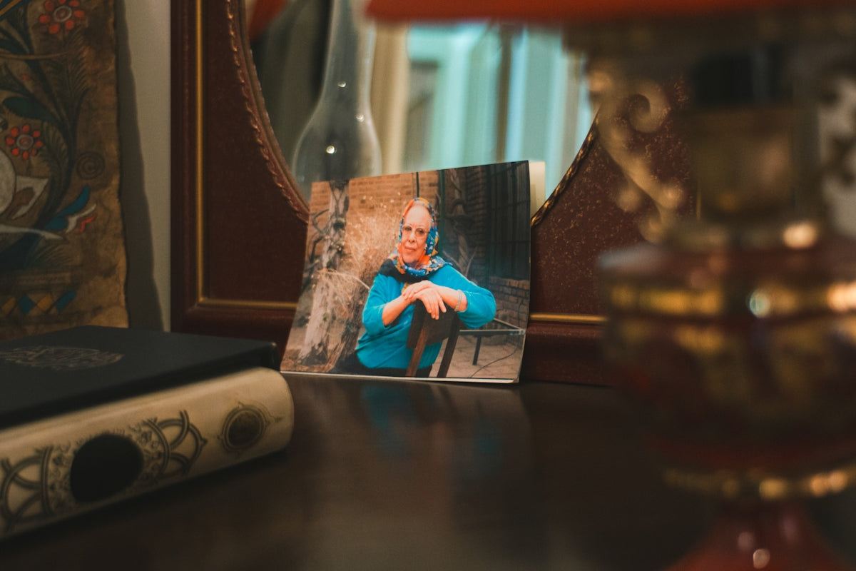 A framed photograph of a person in a blue shirt.