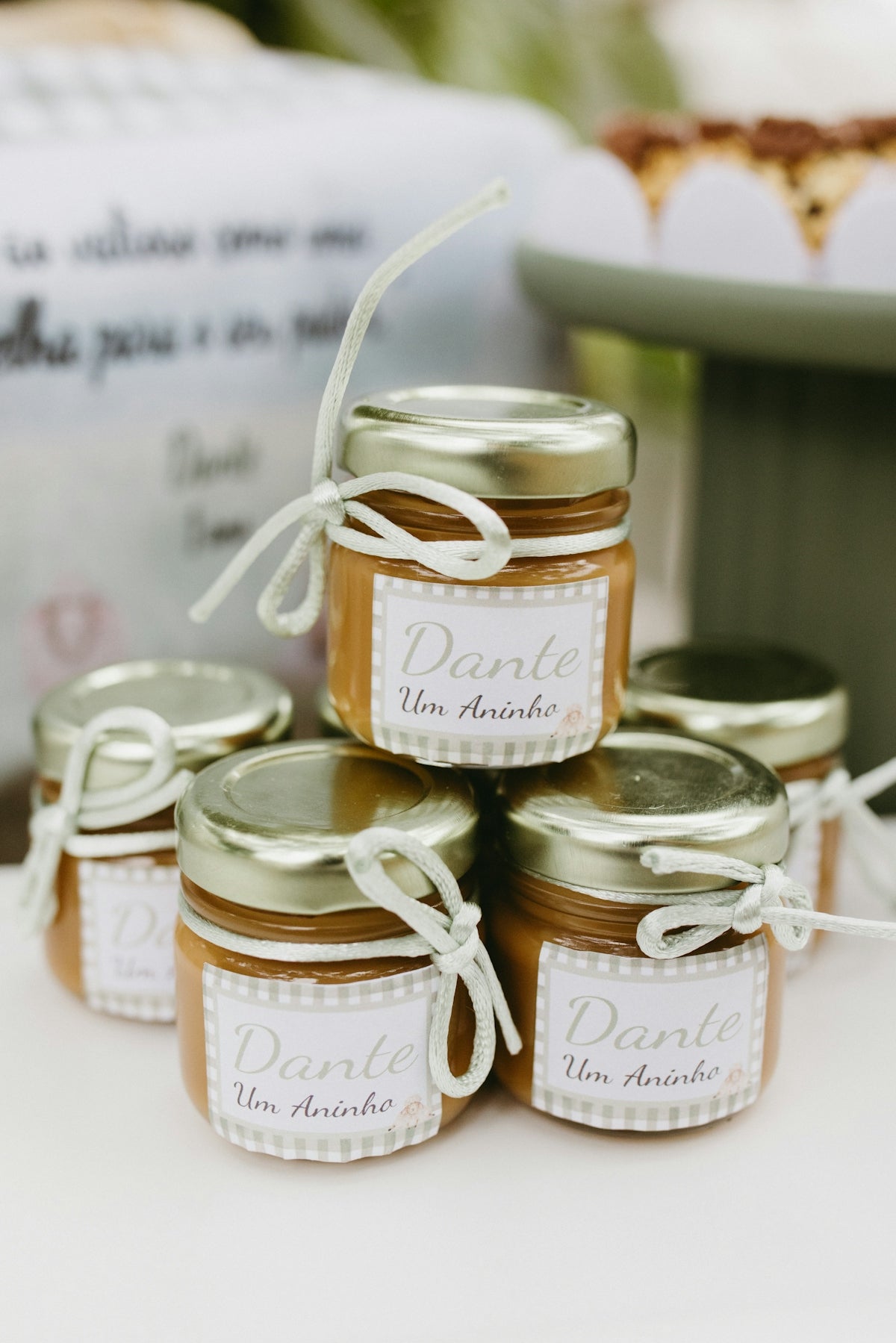 Small jars of caramel candy tied with white ribbon