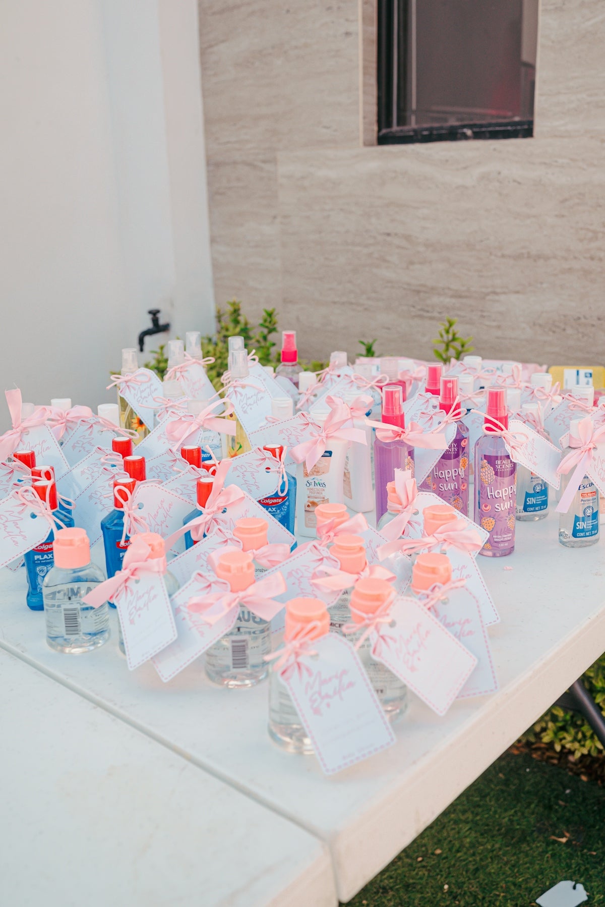 Bottles of hand sanitizer with pink bows and tags